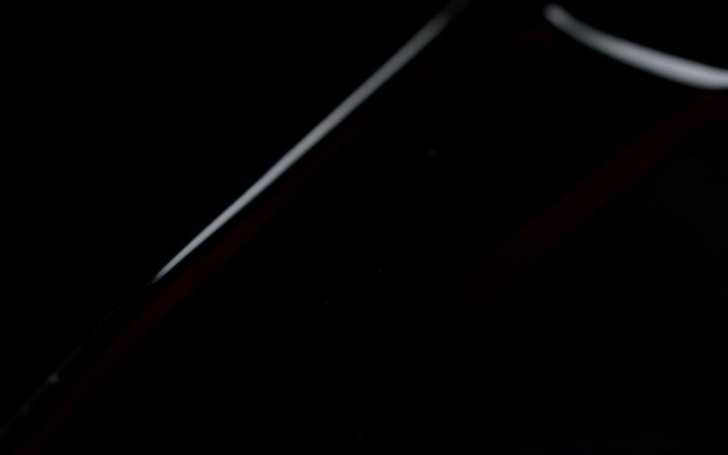 Abstract dark glass with oxblood reflection representing Life Agro