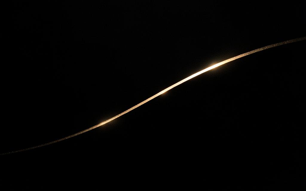 Dark glass with a warm gold light line representing Nomura strategy work